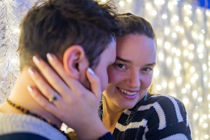 Ava smiling at the camera with her hand on Bran’s cheek