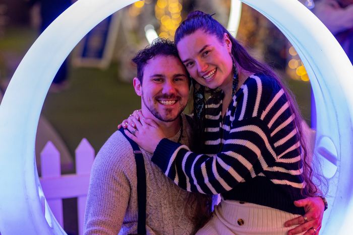 Ava and Bran smiling inside a glowing white ring