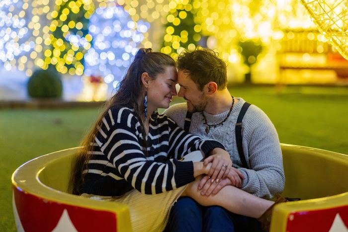 Ava and Bran touching foreheads in a giant teacup ride